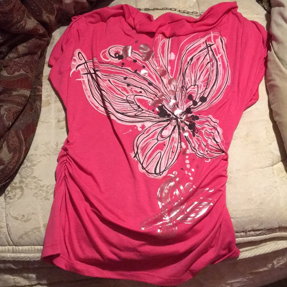 A pink butterfly and floral blouse.